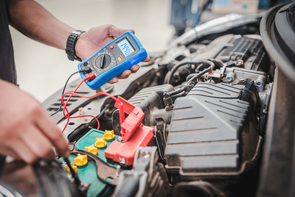 Auto electrical diagnostics in Hanover, PA by Alex Autoworks. Image showing a mechanic using a multimeter to test a car battery and electrical system, emphasizing accurate diagnostics and reliable auto repair services.