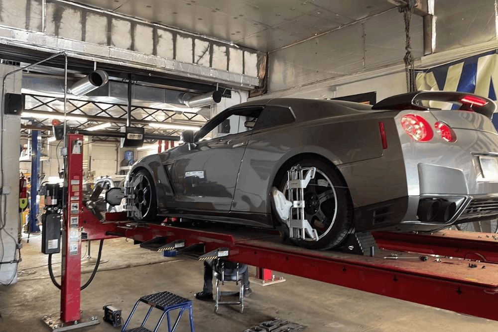 Wheel alignment in Hanover, PA by Alex’s Autoworks. Image of a high-performance vehicle on an alignment rack with precision sensors attached, highlighting accurate wheel alignment, suspension tuning, and improved handling for performance.