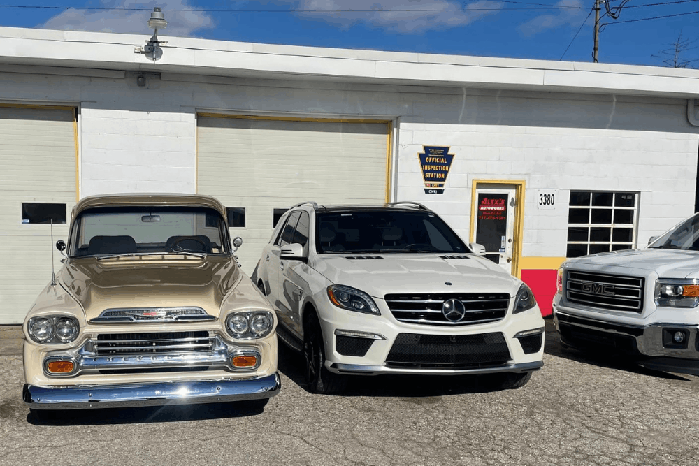PA State Inspection in Hanover, PA at Alex’s Autoworks. Image of shop exterior with classic and modern vehicles, highlighting trusted service for domestic and European cars with quality workmanship and reliable care.