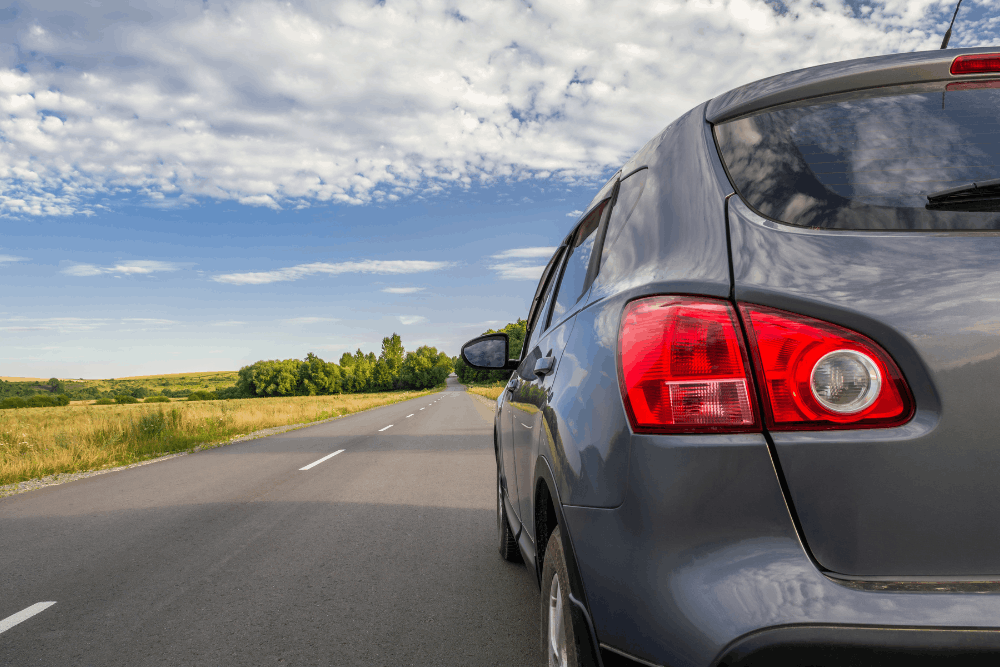 Preventative maintenance, auto repair in Hanover, PA, at Alex's Autoworks. Gray SUV driving on an open highway, representing the importance of preventative vehicle maintenance for safe, reliable performance and worry-free road trips.