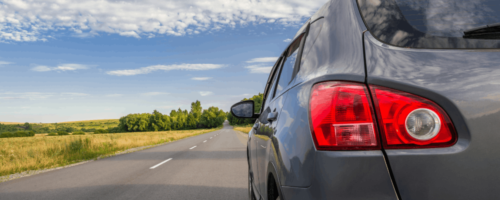Preventative maintenance, auto repair in Hanover, PA, at Alex's Autoworks. Gray SUV driving on an open highway, representing the importance of preventative vehicle maintenance for safe, reliable performance and worry-free road trips.