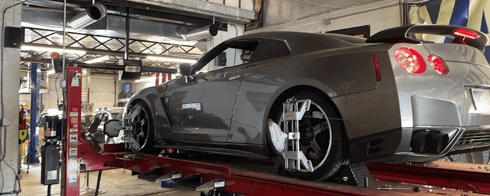 Wheel alignment in Hanover, PA by Alex’s Autoworks. Image of a high-performance vehicle on an alignment rack with precision sensors attached, highlighting accurate wheel alignment, suspension tuning, and improved handling for performance.